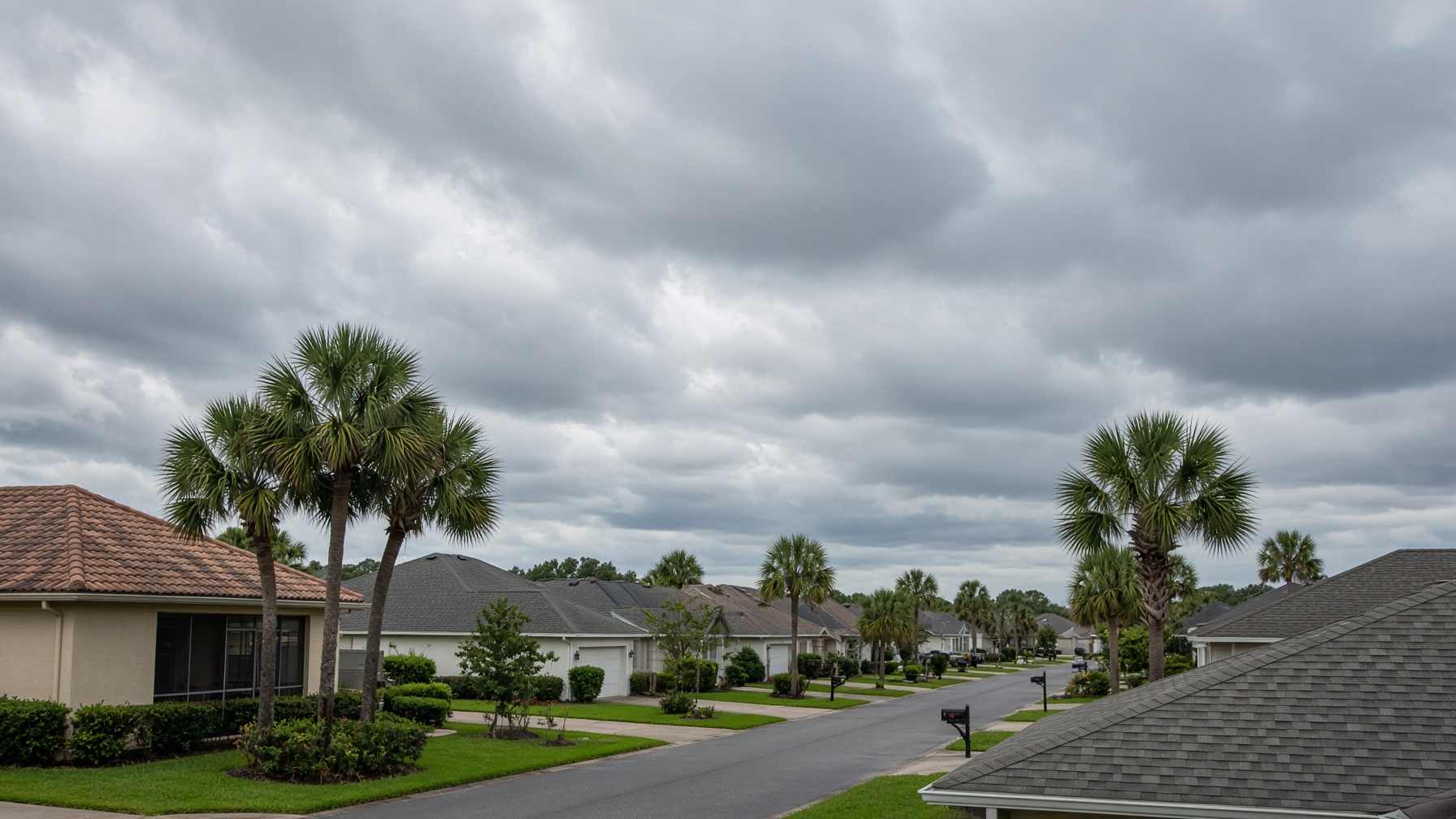 Central Florida neighborhood roofs under a heavy late-summer sky